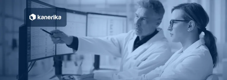 Two healthcare data analysts reviewing clinical and billing data on multiple monitors, illustrating healthcare staff augmentation for IT and data teams