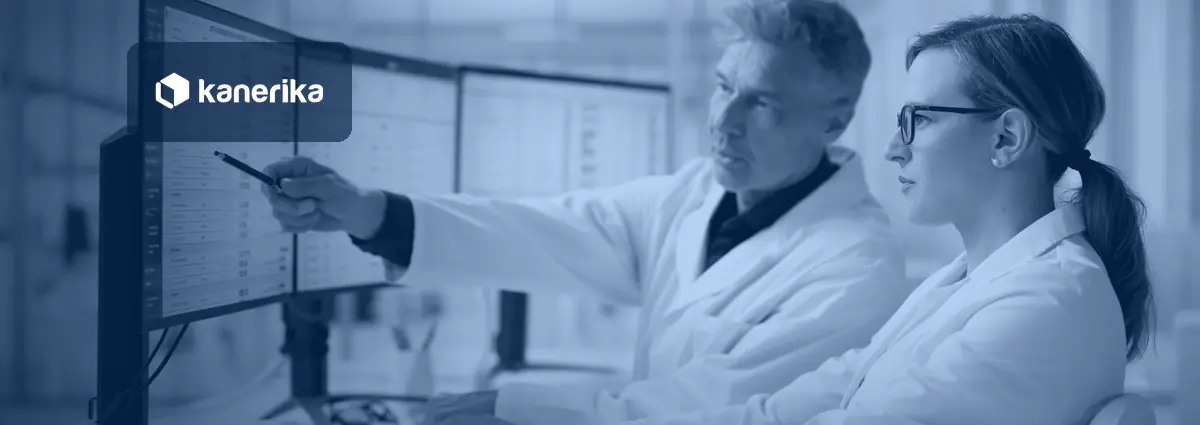 Two healthcare data analysts reviewing clinical and billing data on multiple monitors, illustrating healthcare staff augmentation for IT and data teams