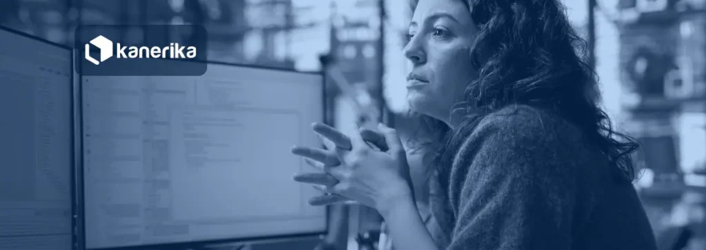 Software engineer reviewing code on a monitor, illustrating Jev AI use cases for enterprise decision automation