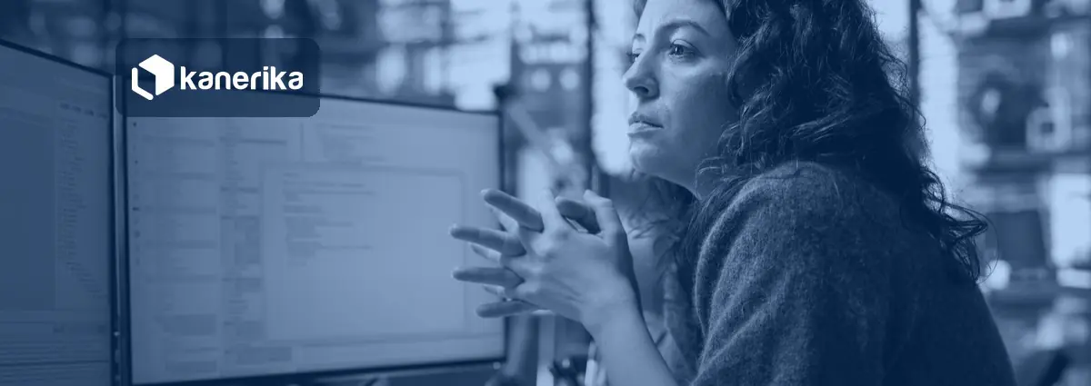 Software engineer reviewing code on a monitor, illustrating Jev AI use cases for enterprise decision automation