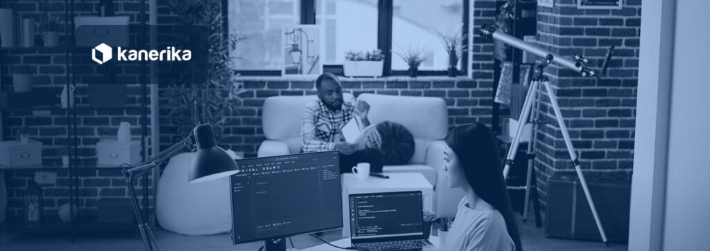 Software engineer working on Keras and TensorFlow deep learning code on dual monitors, Kanerika