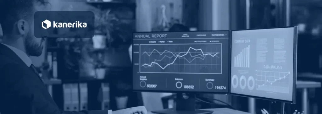 Business intelligence manager reviewing automated Power BI report dashboards on two monitors, illustrating Power BI automation
