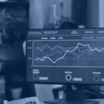 Business intelligence manager reviewing automated Power BI report dashboards on two monitors, illustrating Power BI automation