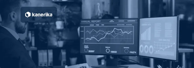 Business intelligence manager reviewing automated Power BI report dashboards on two monitors, illustrating Power BI automation