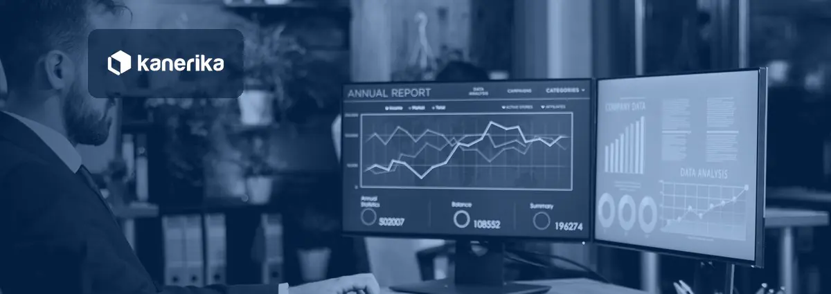 Business intelligence manager reviewing automated Power BI report dashboards on two monitors, illustrating Power BI automation