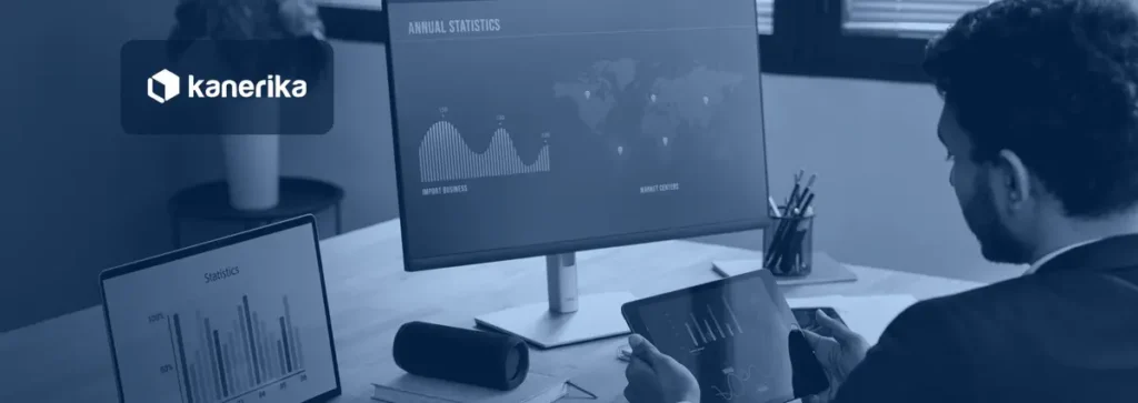 Analyst comparing a spreadsheet chart on a laptop with a business dashboard on a monitor, illustrating Power BI vs Excel for reporting