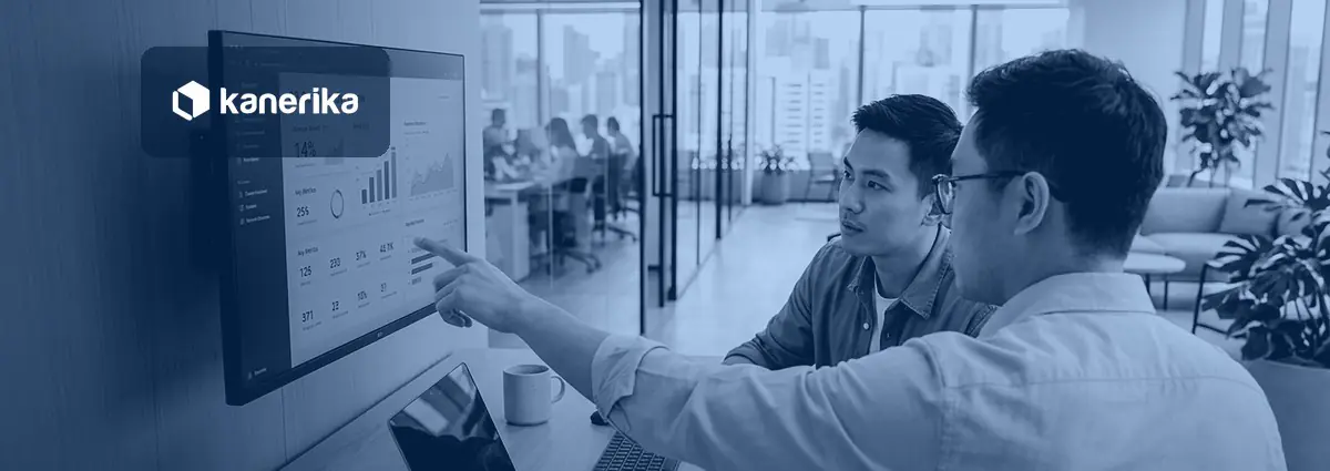 Qlik Sense vs Power BI comparison banner showing two colleagues reviewing a business intelligence dashboard on an office display