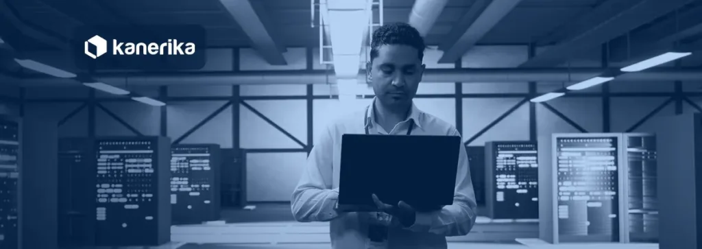 Engineer with a laptop in a data center planning SAP data migration tools and platform moves, Kanerika banner