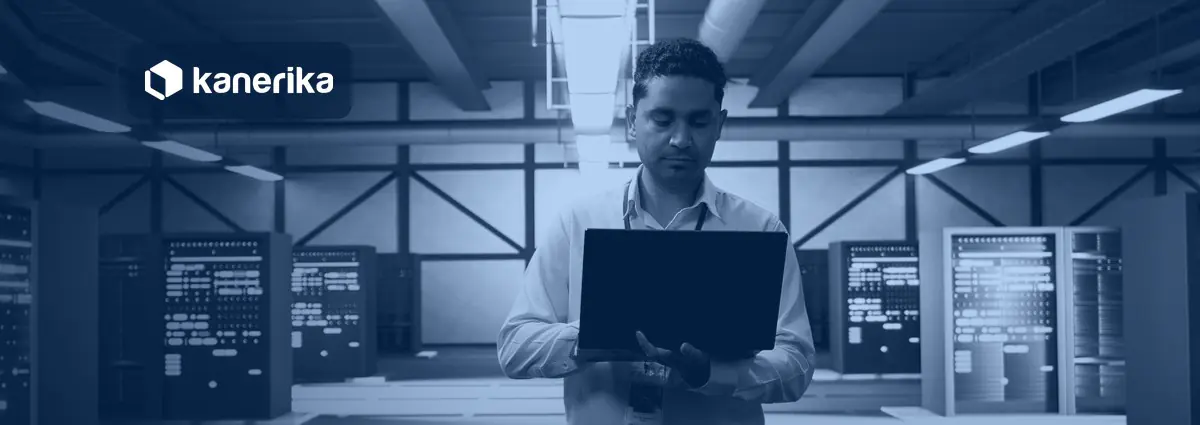 Engineer with a laptop in a data center planning SAP data migration tools and platform moves, Kanerika banner