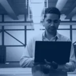 SAP HANA migration banner showing a Basis engineer with a laptop in a data center during a database migration