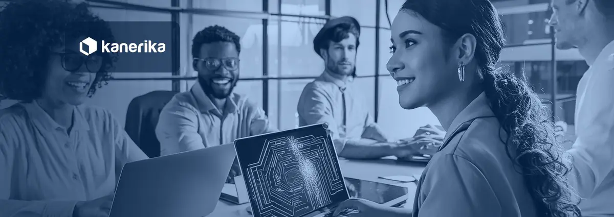 Four colleagues in a bright office meeting in a navy-blue tint, one smiling beside a laptop showing an AI circuit graphic, with the Kanerika logo, for a guide to successful AI adoption
