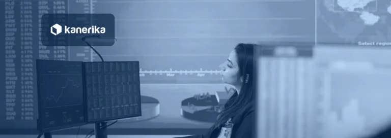 Analyst seated at a workstation with data dashboards on a large wall screen, in a navy-blue tint with the Kanerika logo, for a post on AI agent orchestration