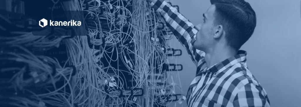 Data engineer tracing cables in a server rack, navy-toned Kanerika banner for AI data pipelines