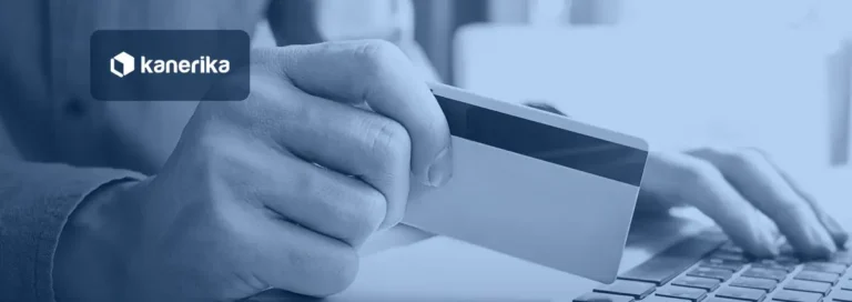 Close-up of a hand holding a payment card above a laptop keyboard, in a navy-blue tint with the Kanerika logo, for a post on AI in fraud detection