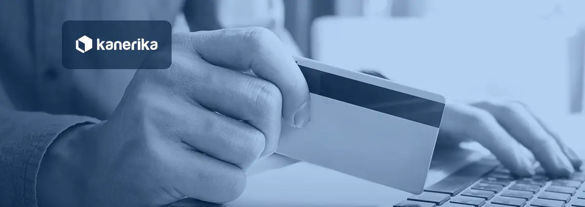Close-up of a hand holding a payment card above a laptop keyboard, in a navy-blue tint with the Kanerika logo, for a post on AI in fraud detection