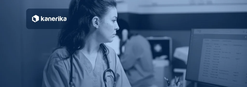 Nurse in blue scrubs reviewing an appointments list on a clinic computer monitor, Kanerika banner for automation in healthcare