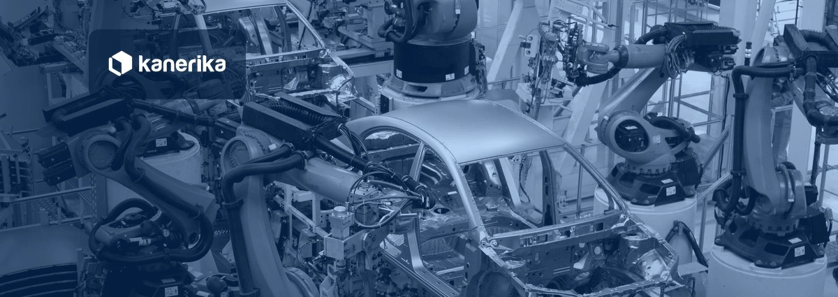 Robotic arms welding car bodies on an automotive assembly line, navy-toned Kanerika banner for data analytics in the automotive industry