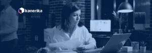 Professional reviewing business documents on a laptop in a dim office, Kanerika document intelligence blog banner