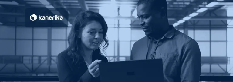 Two data center colleagues reviewing a design on a laptop in a bright server hall, banner for a guide on cloud architecture and what to know before you build