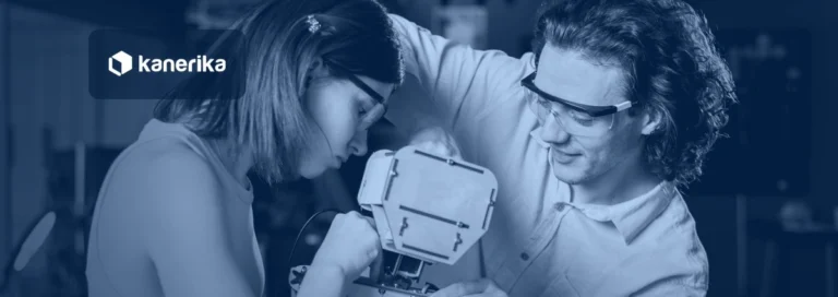 Two engineers building a custom robot together in a lab, navy-toned Kanerika banner for custom AI agents