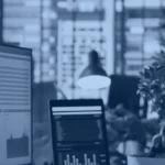 Kanerika blog banner for data accessibility, analytics dashboards on office screens in a bright workspace