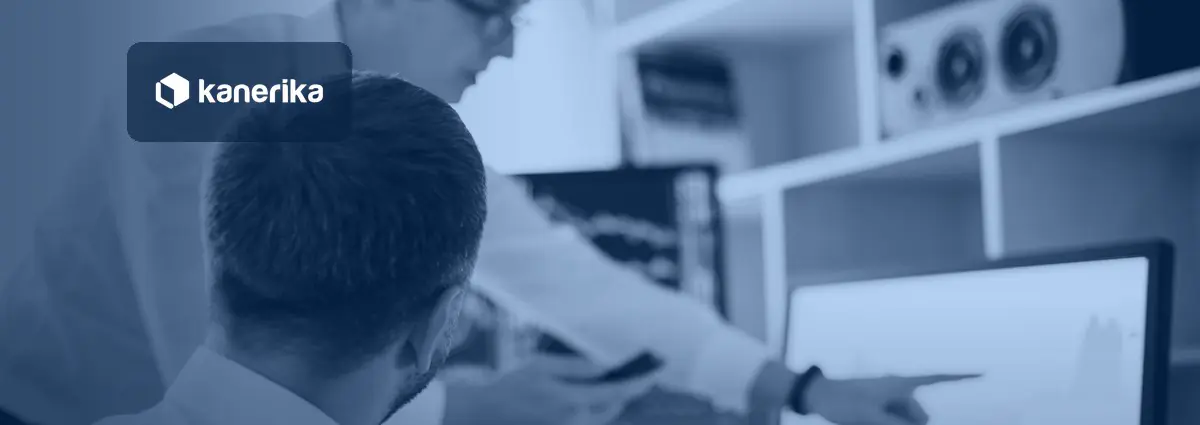 Two colleagues in an office reviewing data charts on a computer screen, a photo representing data analytics trends in 2026