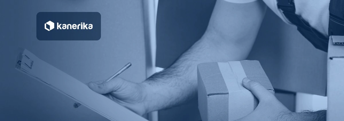 Courier's hand holding a clipboard checklist next to a taped cardboard box, representing a data migration checklist, shown in a navy blue tint with the Kanerika logo