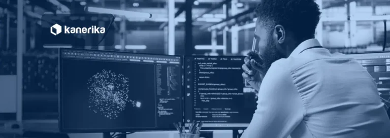 Developer at a dual-monitor workstation in a data center reviewing code and a cluster diagram, representing Databricks performance optimization
