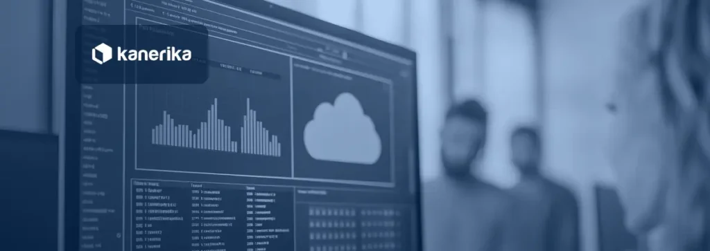 Team of professionals reviewing a cloud data performance dashboard with charts on a large monitor in a modern office