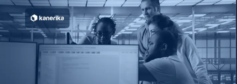 Multiethnic team of engineers gathered around a screen in a server hub, Kanerika banner for enterprise data integration