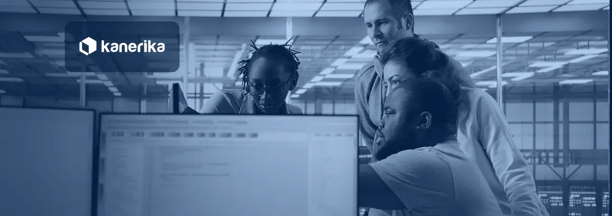 Multiethnic team of engineers gathered around a screen in a server hub, Kanerika banner for enterprise data integration