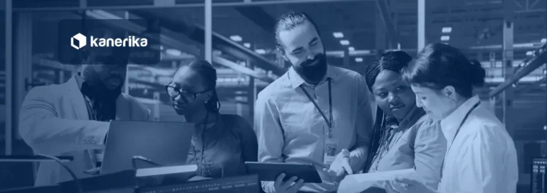 Five colleagues in a data center reviewing an AI model on monitors, a laptop and a tablet