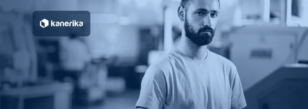 Young engineer holding a tablet on a factory floor beside CNC machines, representing generative AI use cases in manufacturing