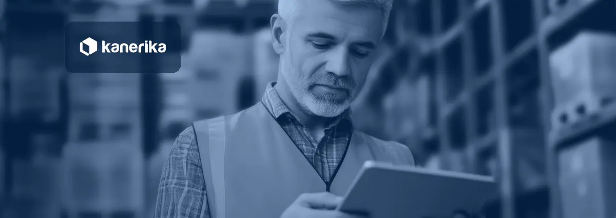 Warehouse supervisor in an orange safety vest checking supplier and shipment details on a tablet between tall storage racks, in a navy-blue tint, for a post on generative AI for supply chain