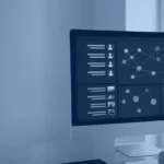 Analyst reviewing a business intelligence dashboard on a desktop monitor, hero image for business intelligence statistics 2026
