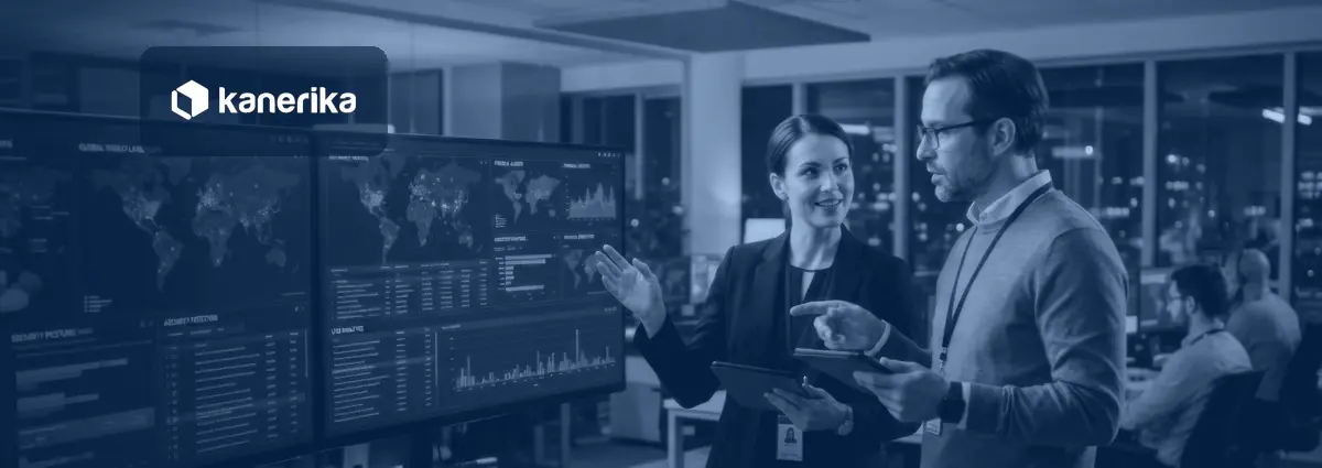 Data analysts in a control room reviewing connected data dashboards for a data fabric architecture