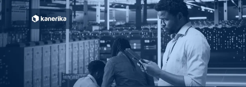 Engineers reviewing data pipeline architecture next to server racks in a data center
