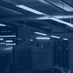 Two data engineers reviewing platform performance benchmarks in a server hub, Databricks vs Snowflake comparison banner
