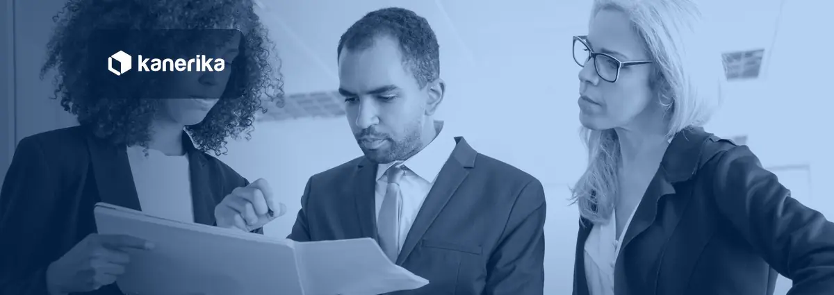 Three colleagues reviewing a document together, illustrating how a team writes and reviews a generative AI policy