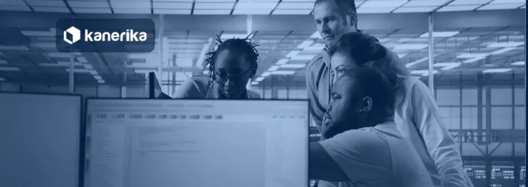 Data engineers reviewing a workspace on a monitor for a Databricks to Microsoft Fabric migration