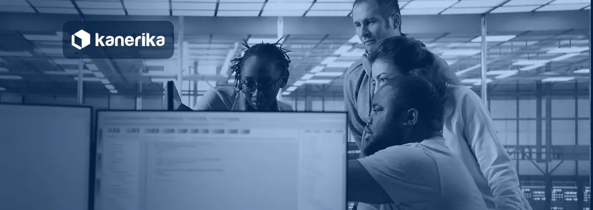 Data engineers reviewing a workspace on a monitor for a Databricks to Microsoft Fabric migration