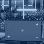 Engineer monitoring a neural network on screens in a data center, illustrating how large language model architecture runs on compute