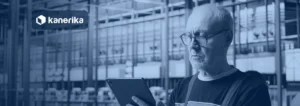 Plant engineer reviewing production data on a tablet in a factory, banner image for the Kanerika guide to manufacturing data analytics