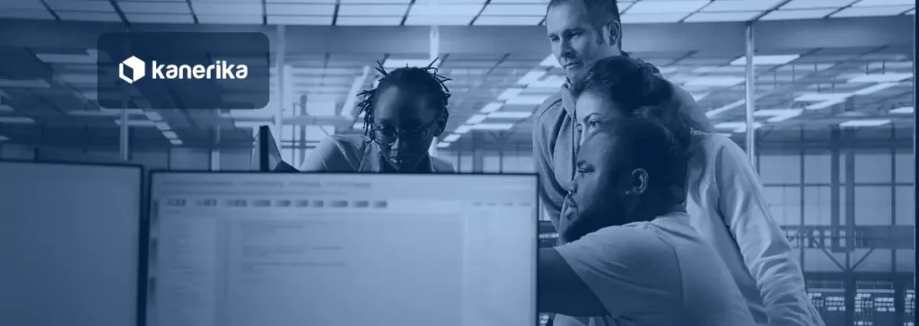 Engineering team reviewing data on a shared screen for Microsoft Fabric OneLake shortcuts architecture
