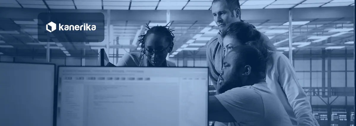 Engineering team reviewing data on a shared screen for Microsoft Fabric OneLake shortcuts architecture