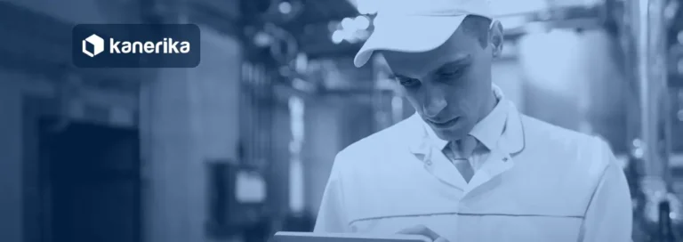 Technologist in a white coat using a tablet on a food factory floor, banner image for the Kanerika QAD Fabric mirroring guide