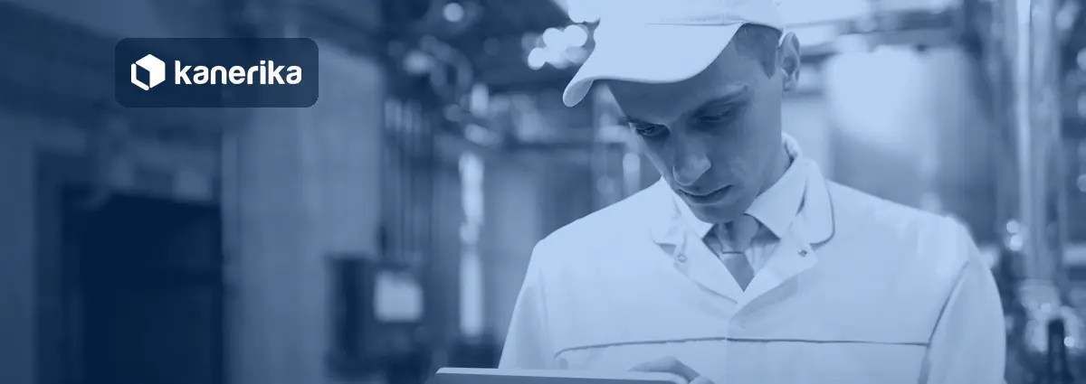 Technologist in a white coat using a tablet on a food factory floor, banner image for the Kanerika QAD Fabric mirroring guide