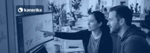 Two colleagues reviewing a data dashboard on a curved monitor, Kanerika banner for Rayfin vs Fabric Apps vs Power BI vs Power Apps