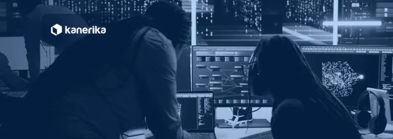 Data engineers reviewing a data flow on screens in a server room, illustrating Snowflake data sharing between accounts