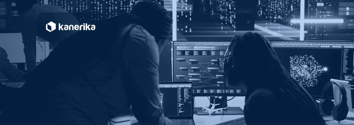 Data engineers reviewing a data flow on screens in a server room, illustrating Snowflake data sharing between accounts